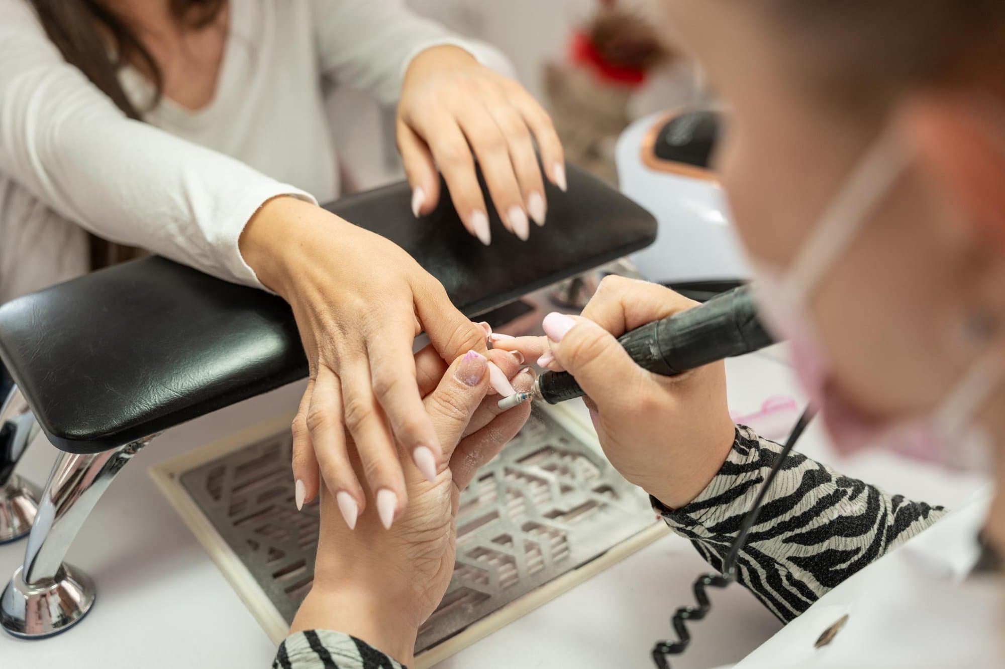 Nail technician performing manicure service